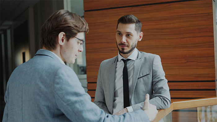 Two businessmen having a serious discussion representing a boss scenario Two businessmen having a serious discussion representing a boss scenario