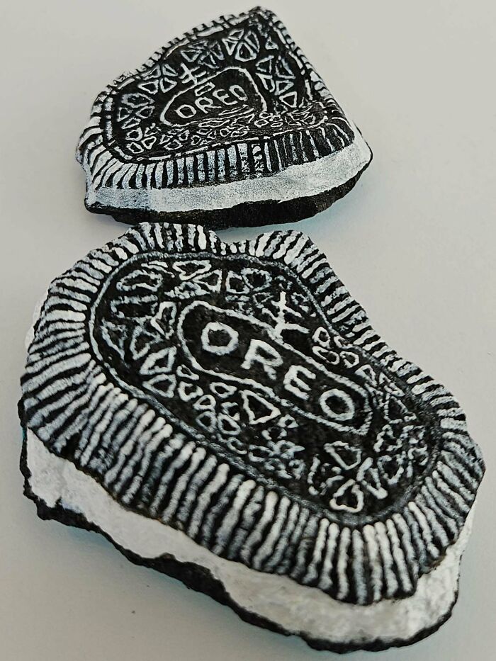 Two colorful stone creations, painted like realistic Oreo cookies with detailed black and white patterns, turning rocks into iconic foods.