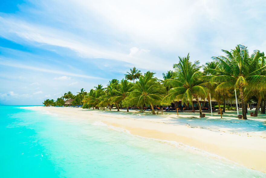 Tropical beach with palm trees and turquoise water in a small country