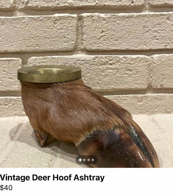 Vintage deer hoof ashtray with a brass rim on a brick surface
