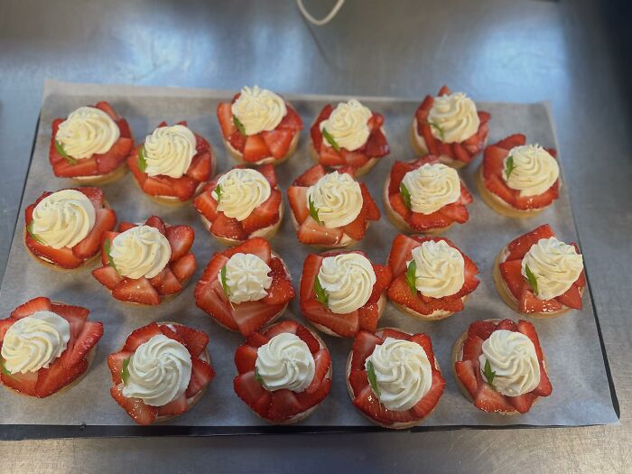 Strawberry and cream desserts neatly arranged on a tray