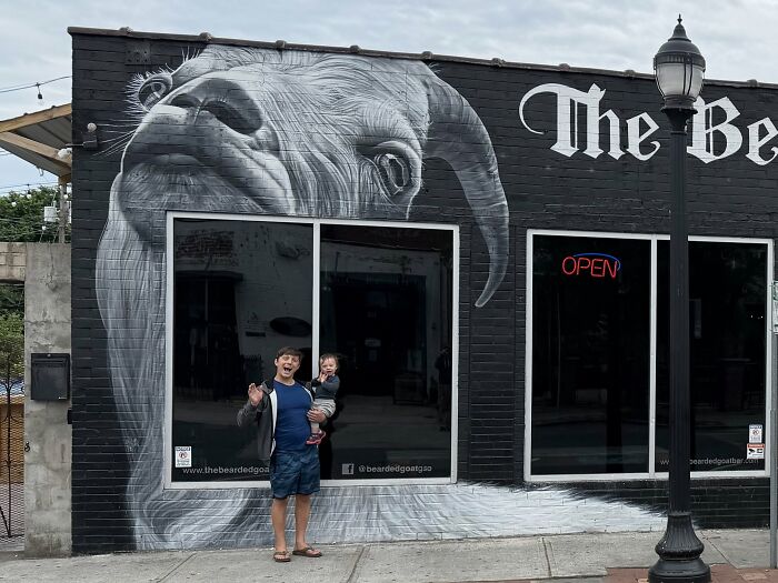 Man with child in front of goat mural representing quitting horrible jobs