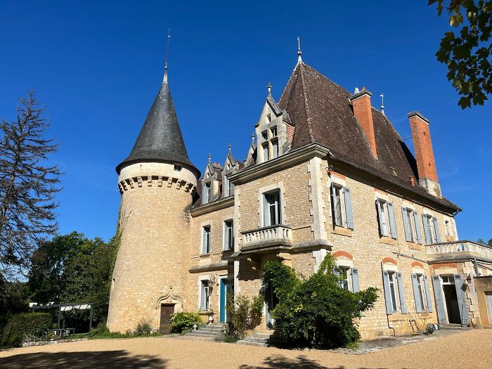 Historic stone castle with tower under clear blue sky