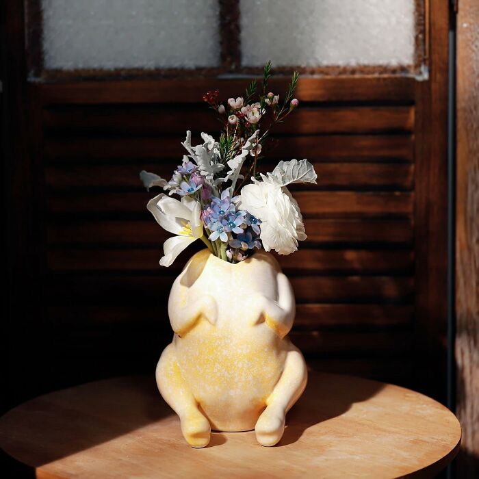 A humorous chicken-shaped vase with flowers, a unique Mother's Day gift for a mom who appreciates humor.