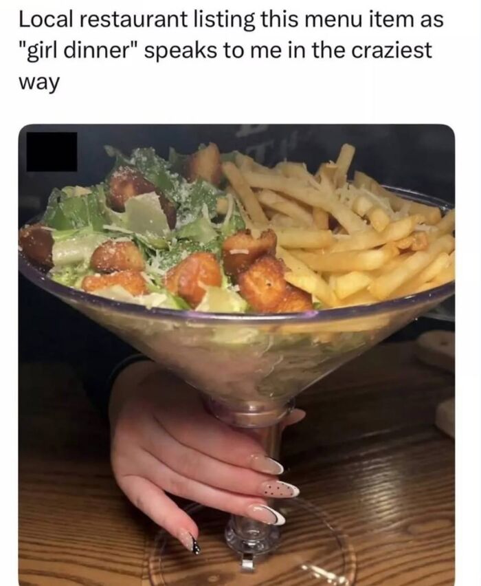 Salad and fries served in a large martini glass called girl dinner