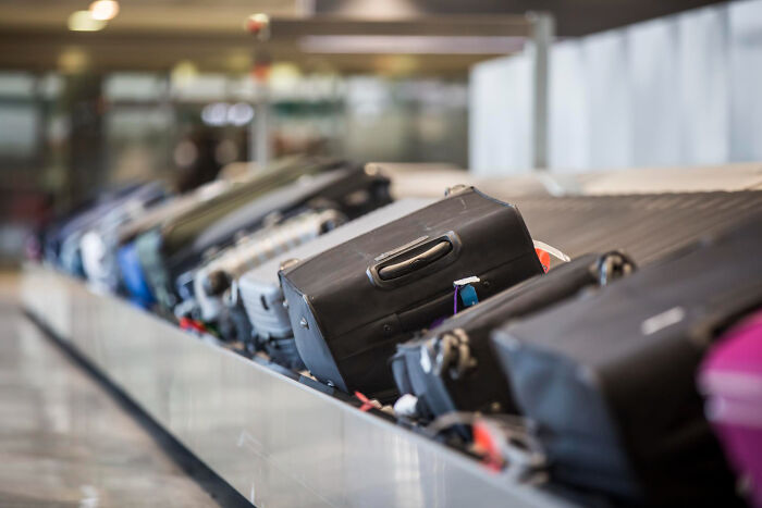 Airport baggage claim carousel with suitcases in motion