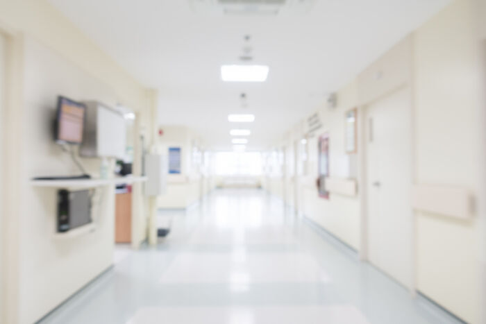 Blurred hospital corridor, a symbolic journey to the other side. This image explores stories that stay with you.