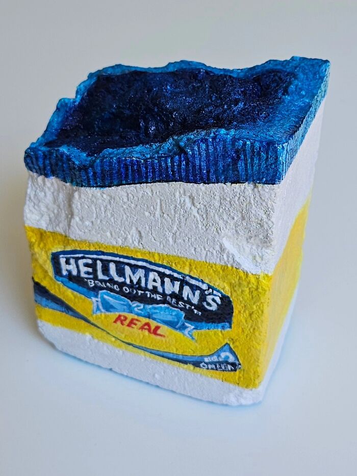 A colorful stone creation, a rock painted as a Hellmann's mayonnaise jar, showcasing iconic foods and famous products art.