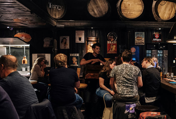 Crowded pub interior with people talking highlighting social PR fail