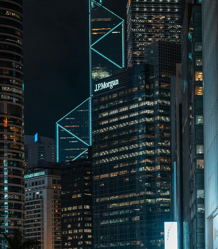 JPMorgan office building illuminated at night in urban cityscape JPMorgan office building illuminated at night in urban cityscape