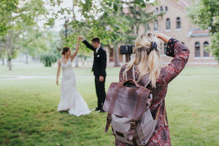 Wedding photographer capturing couple dancing outdoors