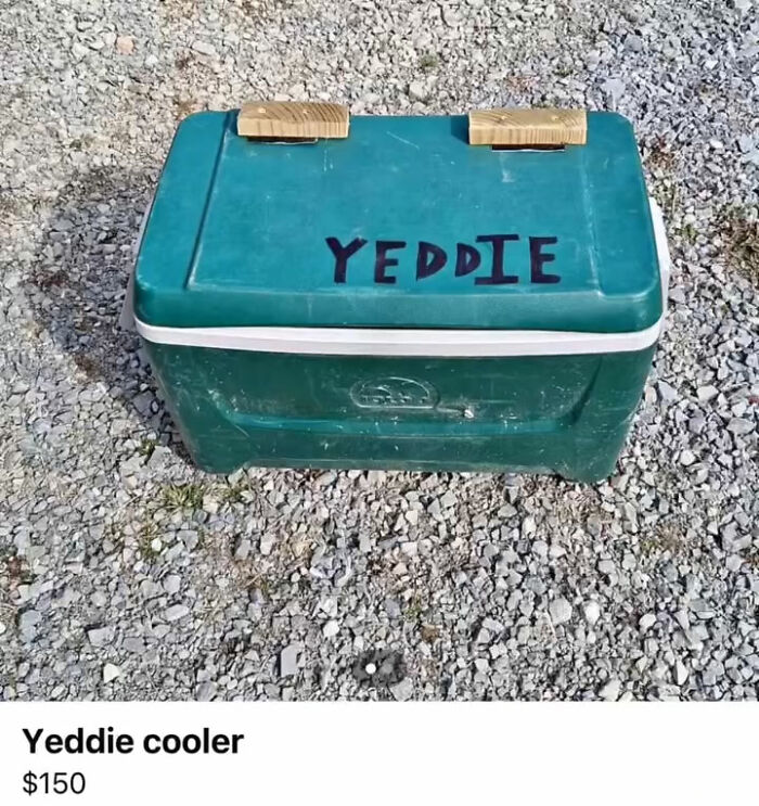 Green Yeddie cooler with wooden handles sitting on gravel