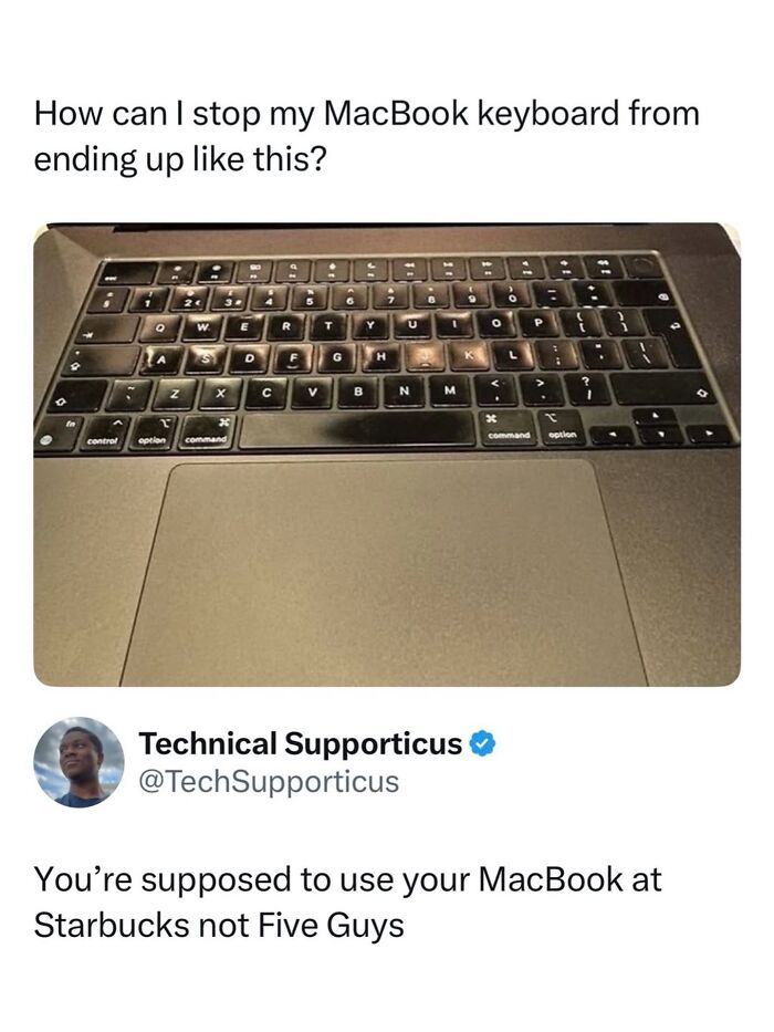 Worn MacBook keyboard with faded keys and dusty surface