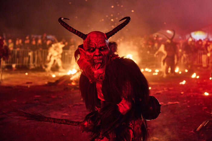 Person in frightening demon costume at a dramatic event