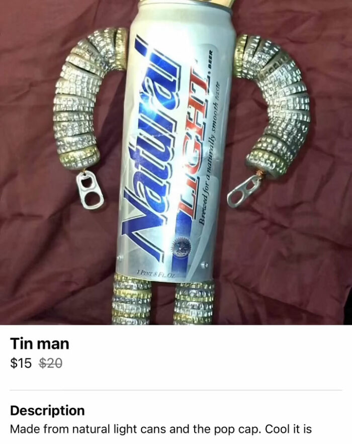 Tin man figure made from natural light beer cans and pop caps on burgundy fabric