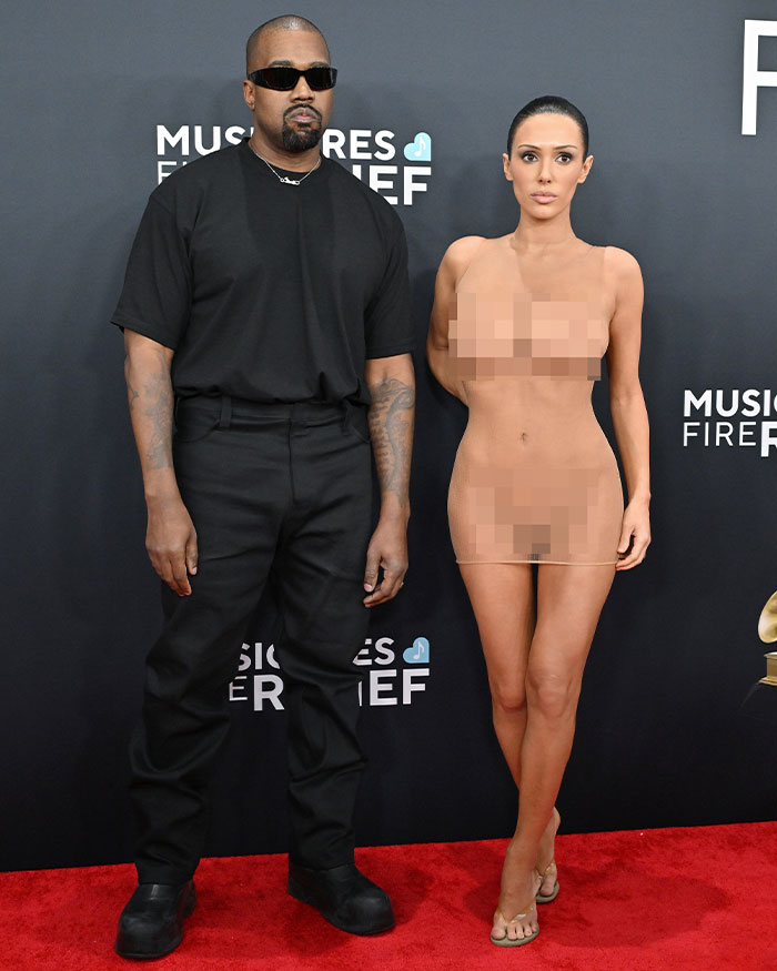 Bianca Censori in a barely-there n**e dress alongside Kanye West, highlighting her unique style choices. Bianca Censori in a barely-there n**e dress alongside Kanye West, highlighting her unique style choices.