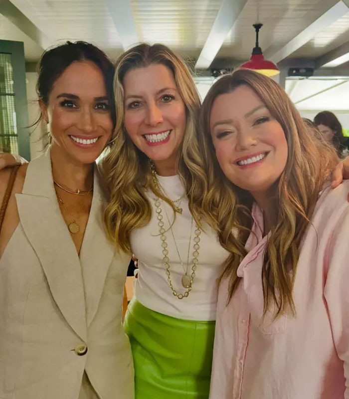 Meghan Markle smiling with two women, wearing her $63,000 necklace, fueling scrutiny after reports of struggling Sussexes. Meghan Markle smiling with two women, wearing her $63,000 necklace, fueling scrutiny after reports of struggling Sussexes.