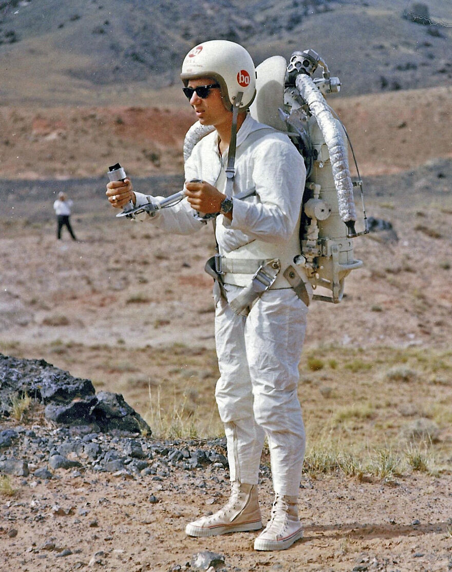 Man wearing vintage rocket pack gear in desert showing past future technology expectations