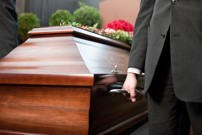 Close-up of coffin being carried at funeral service