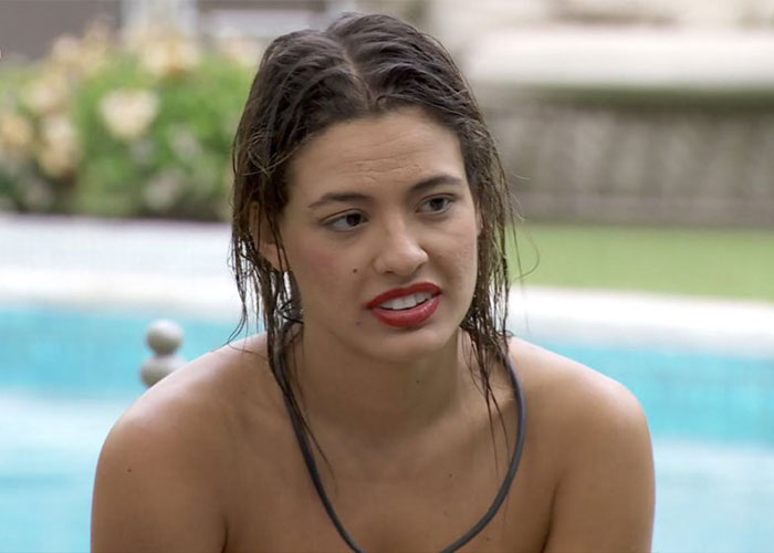 TV star in wet hair and swimsuit discussing Miami restaurant dress code