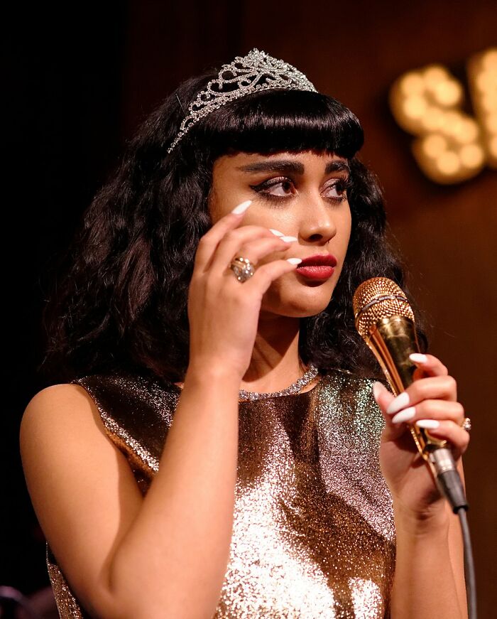 Woman wearing tiara holding microphone symbolizing career ruin