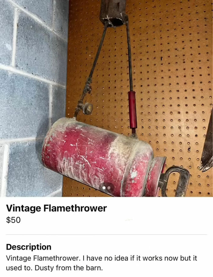 Dusty vintage flamethrower hanging on pegboard wall