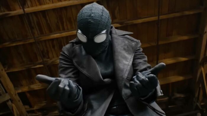 Spider-Noir in black suit and gloves with glowing eyes in dark setting Spider-Noir in black suit and gloves with glowing eyes in dark setting
