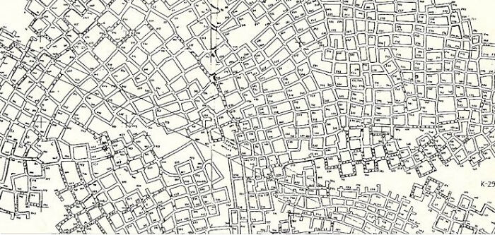 Black and white detailed urban map with complex street layout and buildings