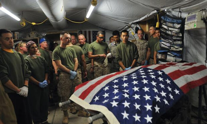 Group of soldiers in uniform gathered around a coffin draped with American flag in creepy photos