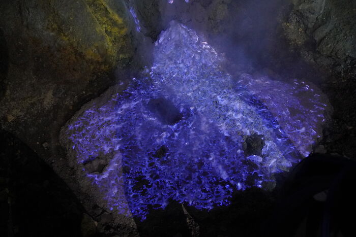 Blue glowing sulfuric blue flames on volcanic rocks geography fact