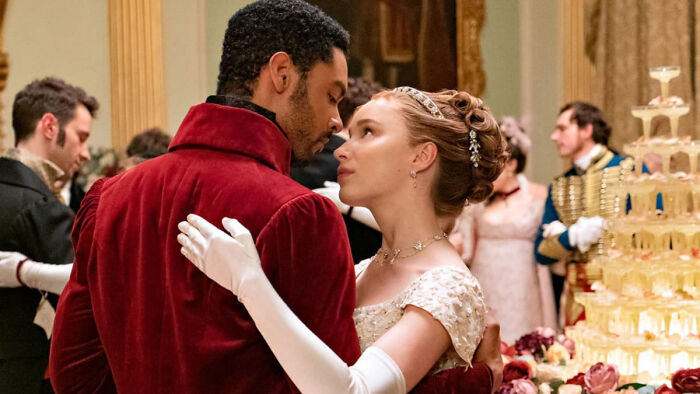 Bridgerton characters dance elegantly at a formal ball Bridgerton characters dance elegantly at a formal ball