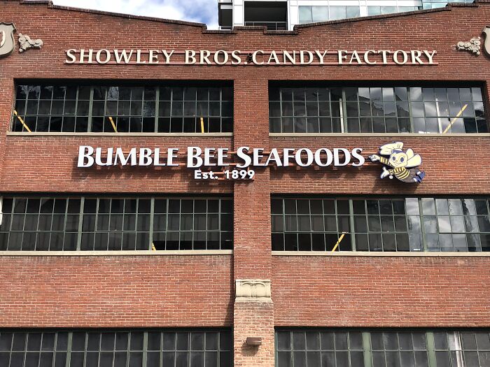 Brick building with Showley Bros. Candy Factory and Bumble Bee Seafoods signs. Disturbing d***h stories come to mind.