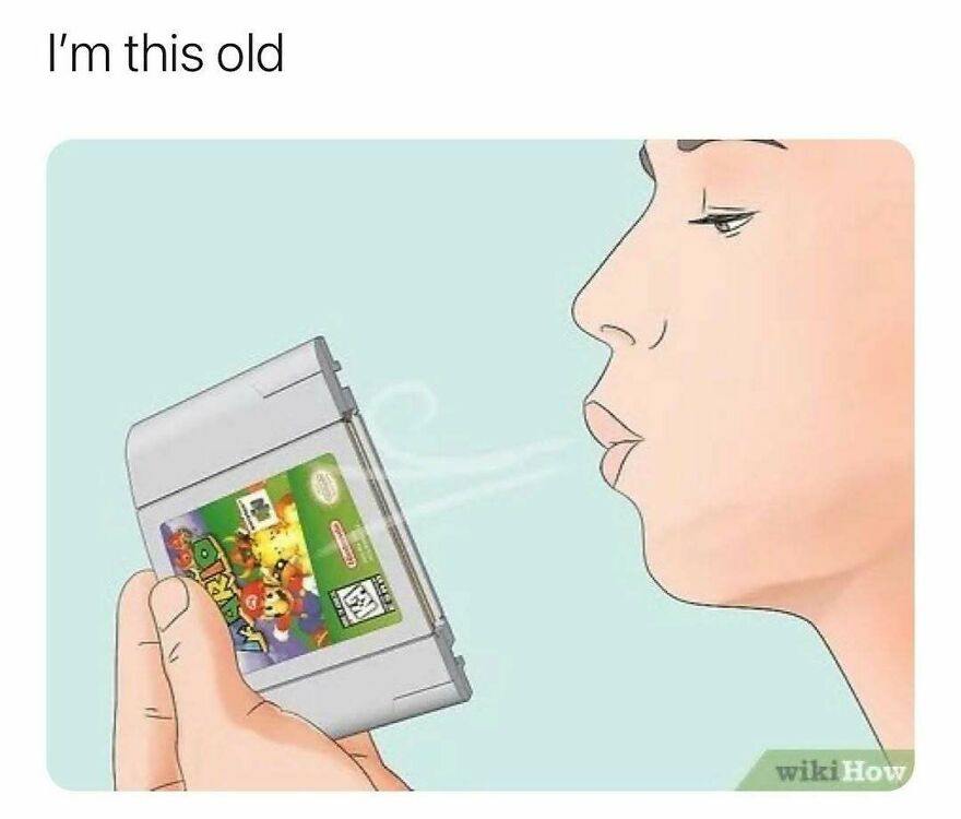 Nostalgic meme blowing on vintage video game cartridge