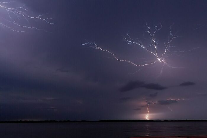 Night sky with lightning over water capturing geography facts