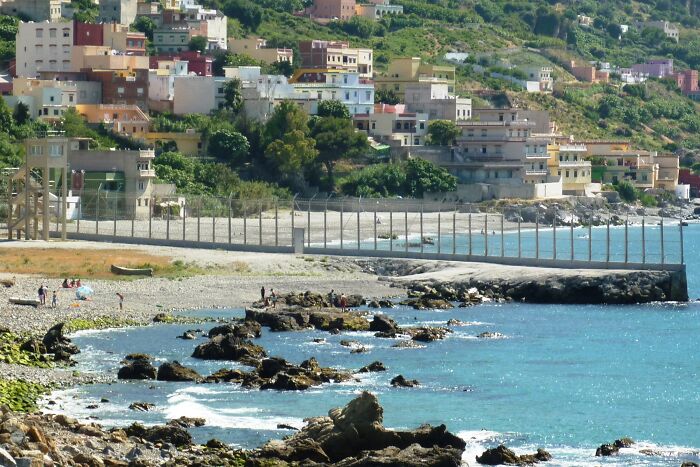 Coastal town with rocky shoreline and turquoise sea water geography facts