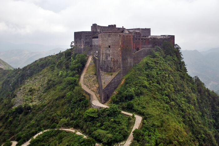 Fortress atop green hill with winding path stunning historic views