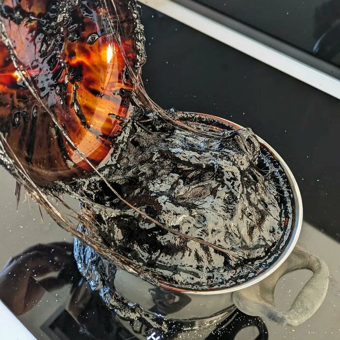 Burnt pot with melted black residue inside from kitchen fail