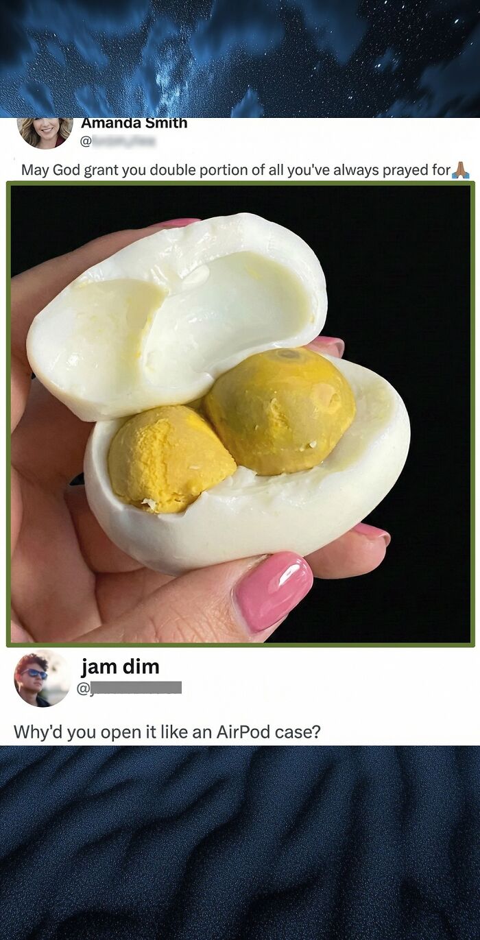 Hand holding a uniquely opened boiled egg with two yolks