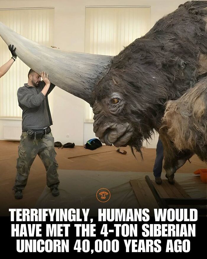 Siberian unicorn sculpture with man holding giant horn, terrifying history facts about prehistoric creatures
