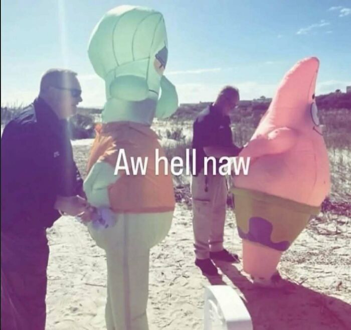 Weird random image of people with giant cartoon character costumes on a beach