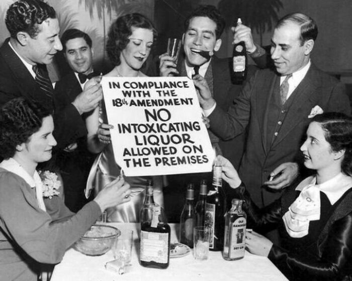 Prohibition era party with sign banning intoxicating liquor under 18th Amendment