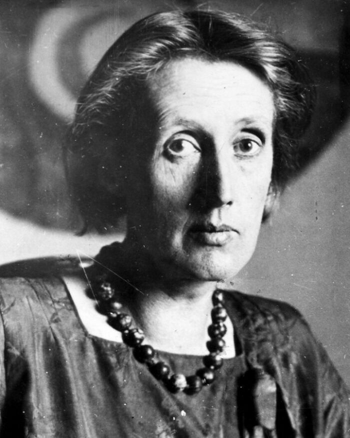 Black and white portrait of a historical woman with a beaded necklace