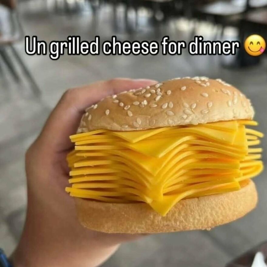 Humorous photo of cheeseburger with multiple slices of unmelted cheese