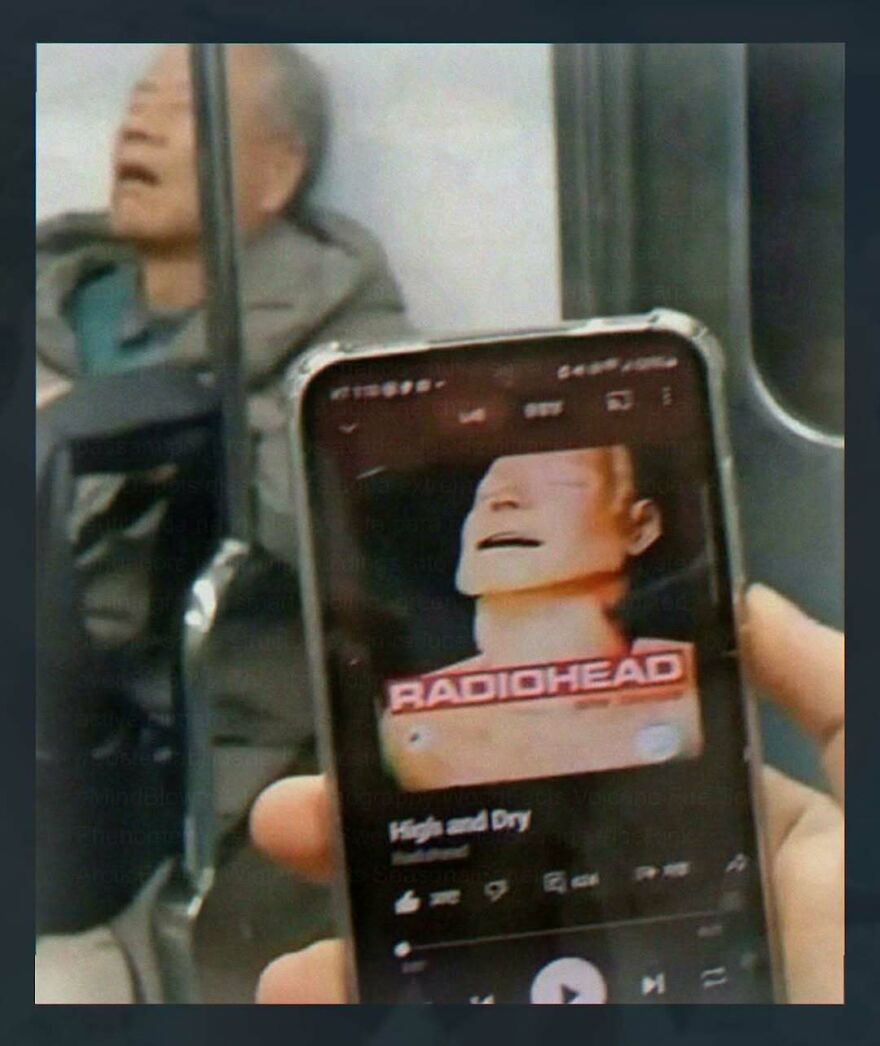 Phone showing Radiohead song High and Dry on music app on subway