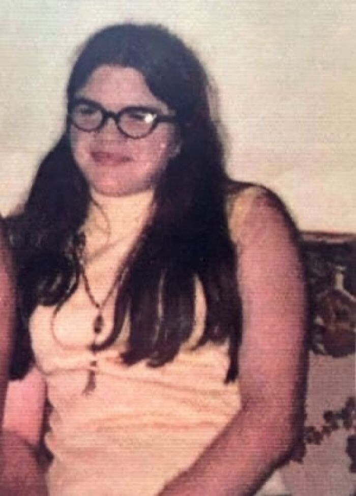 Young woman with glasses and long dark hair in retro photo creepy cases