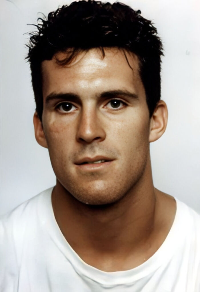 A serious-looking man with dark, messy hair and a white t-shirt, related to disturbing d***h stories.