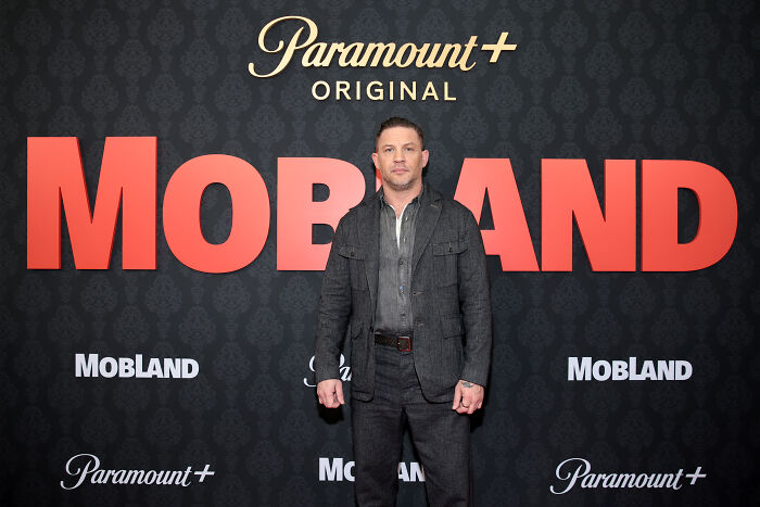 Tom Hardy at Mobland premiere event with large title backdrop Tom Hardy at Mobland premiere event with large title backdrop