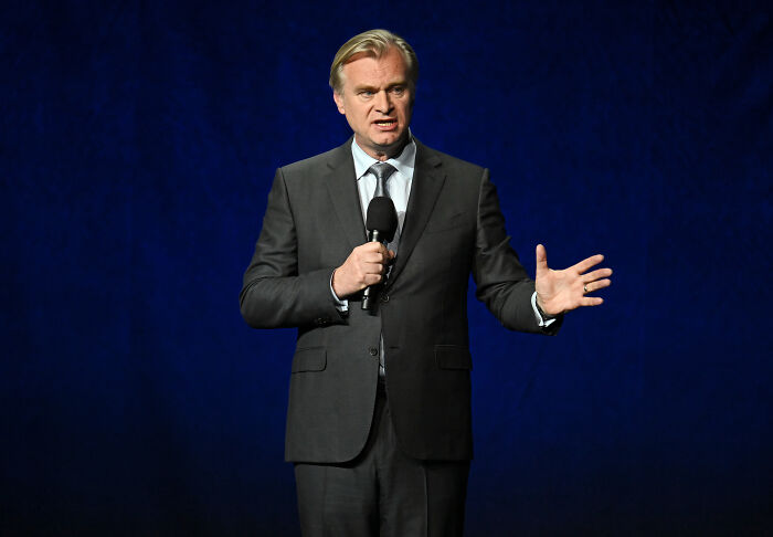 Christopher Nolan speaking on stage, addressing casting comments related to The Odyssey