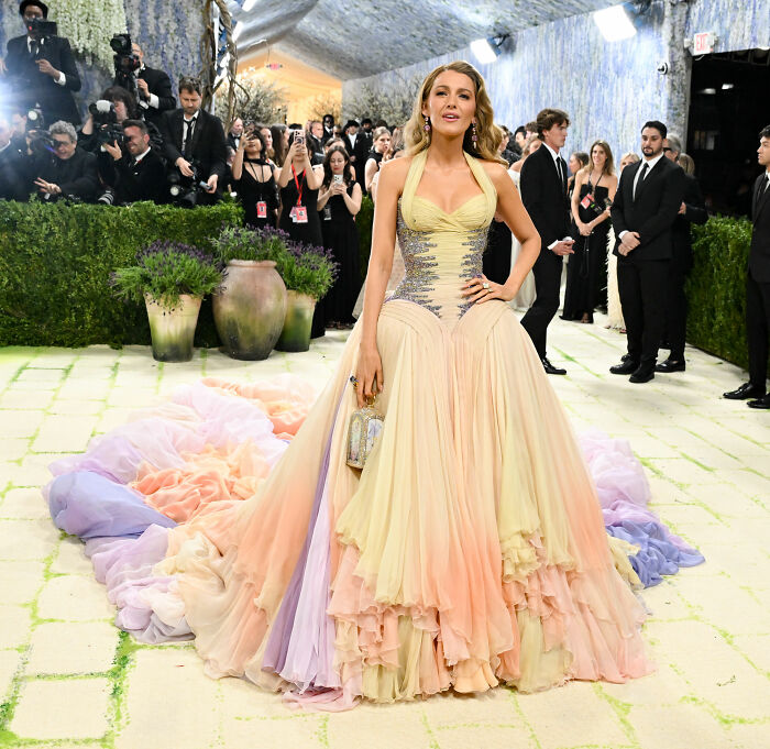 Blake Lively in a jaw-dropping outfit, a pastel ruffled gown with an elaborate train, at the 2026 MET Gala.