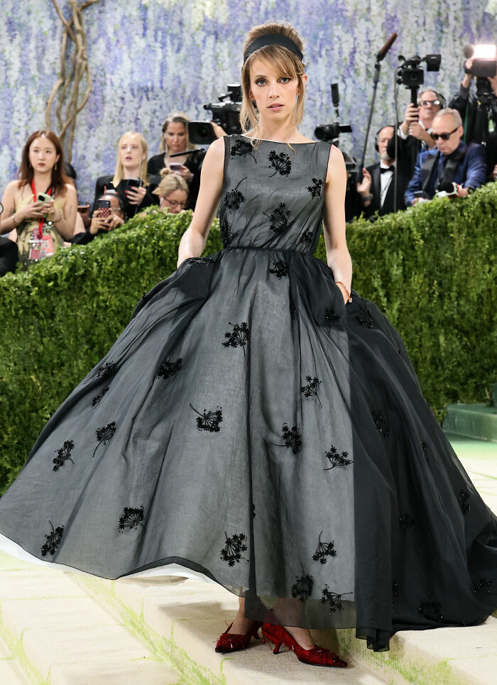 Woman in a stunning black gown with intricate embroidery at the MET Gala 2026, showcasing a jaw-dropping outfit.